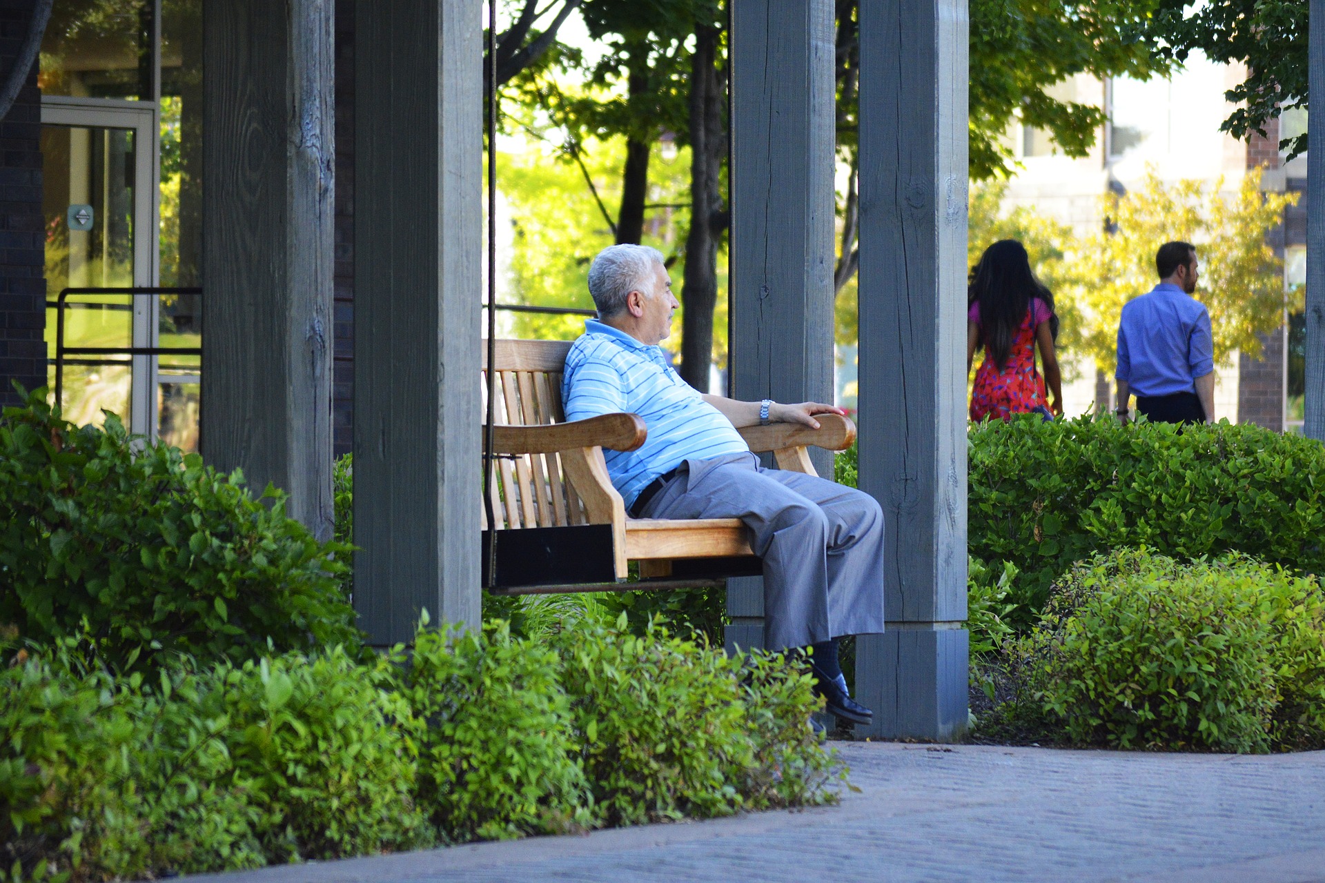 elderly man sitting on a bench