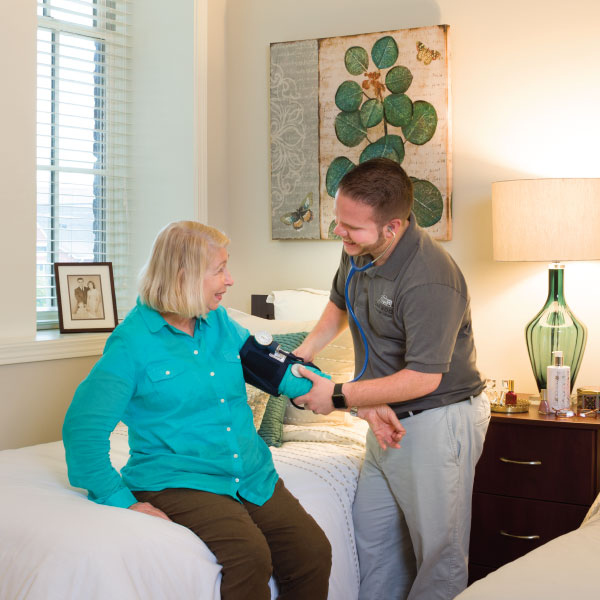 Elderly woman gets heart rate taken at senior solutions