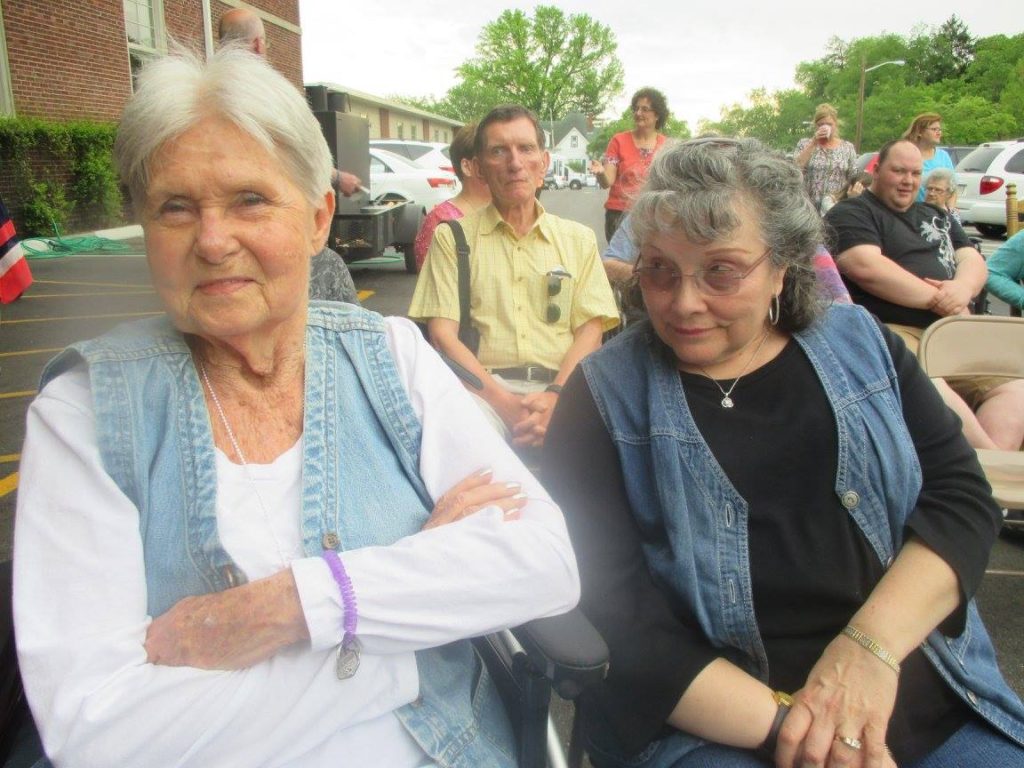 Two assisted living residents enjoying an event at Oakwood Senior Living