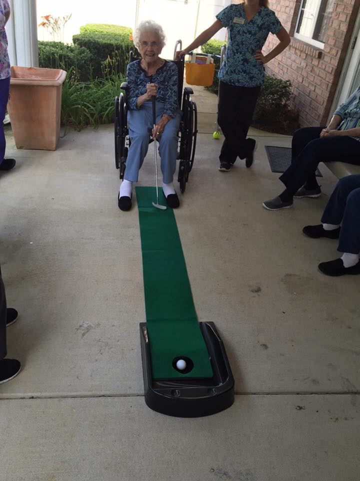 Assisted Living Resident enjoying outdoor putt putt activity