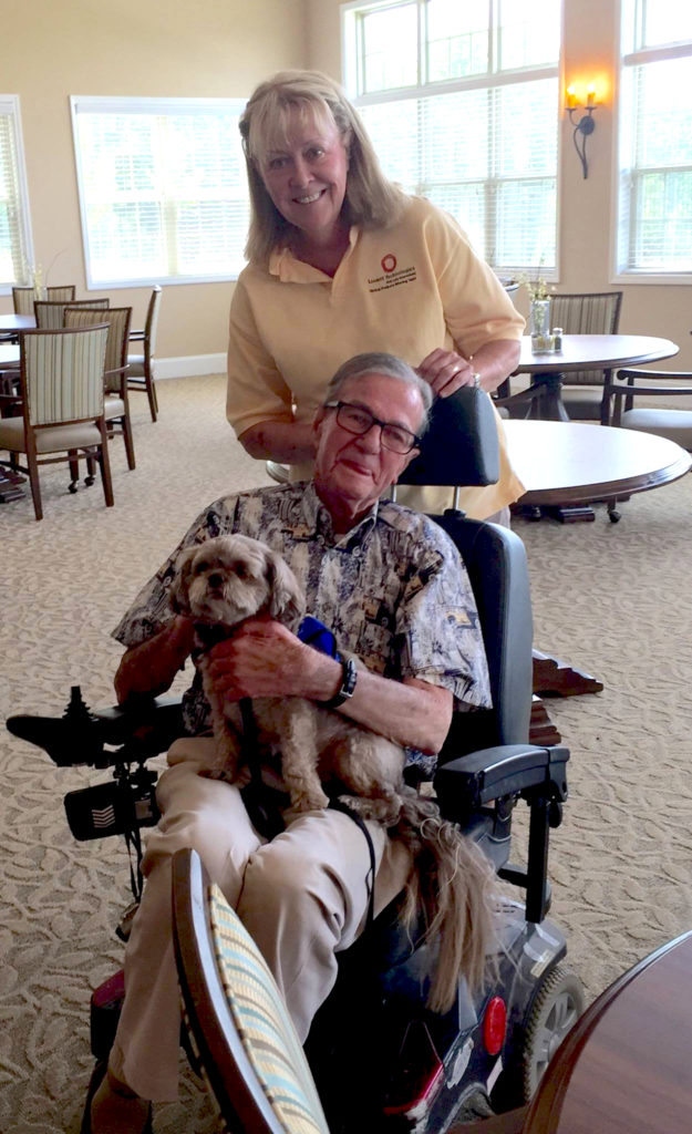Senior Living resident with dog and caregiver